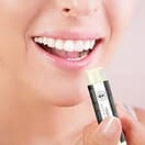 a lady applying lip balm